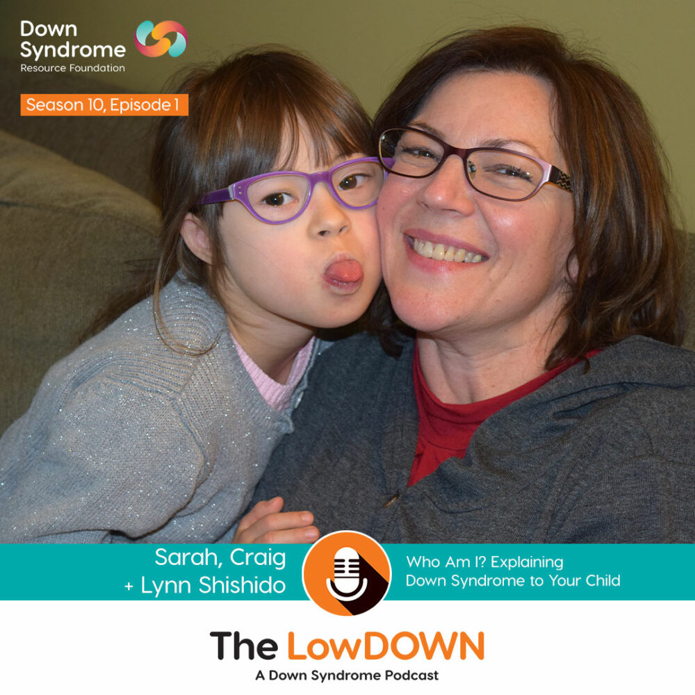 brown haired girl with Down syndrome with glasses and grey shirt sticks out tongue while leaning her face against her mother's face; mother is brown-haired with glasses